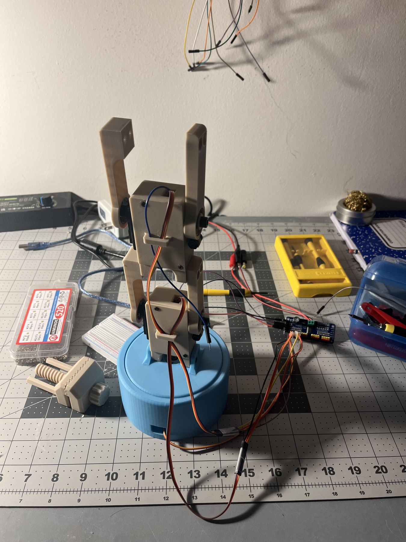 The first full arm on a blue printed base wired to an Arduino and PCA9685